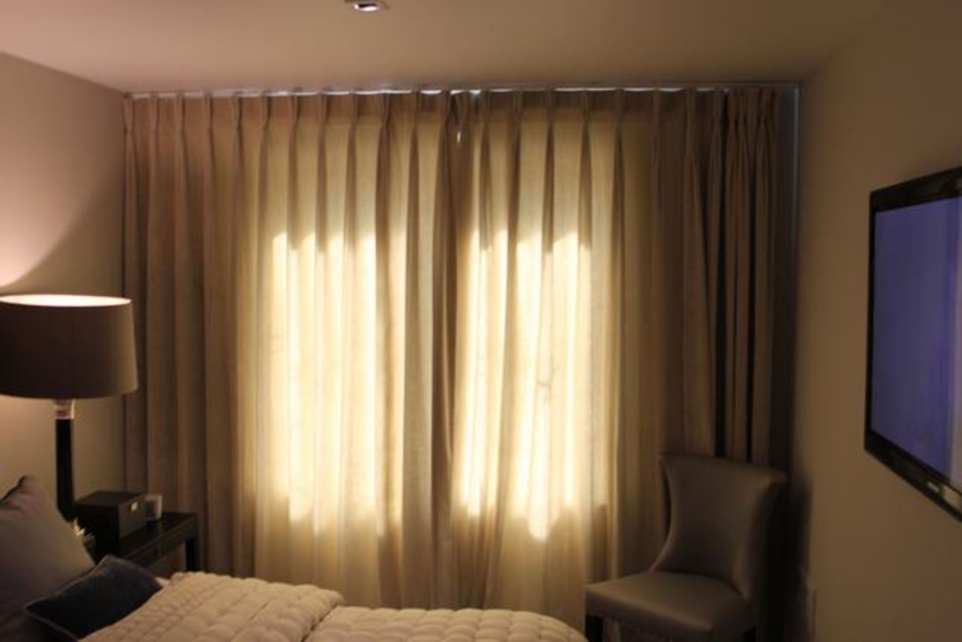 A pair of cream fully lined curtains 2600mm x 2400mm