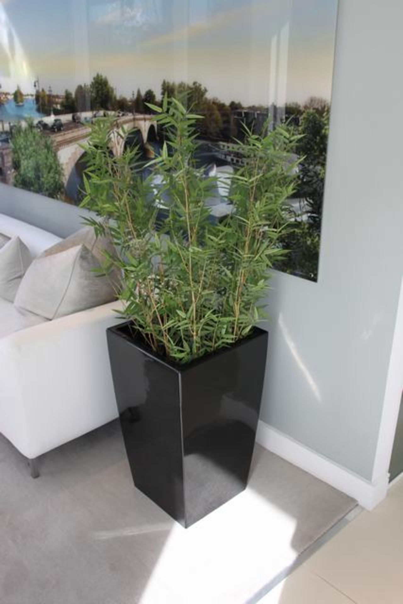 A pair of black cubico planters tapered planter that is lightweight, durable, UV and frost resistant