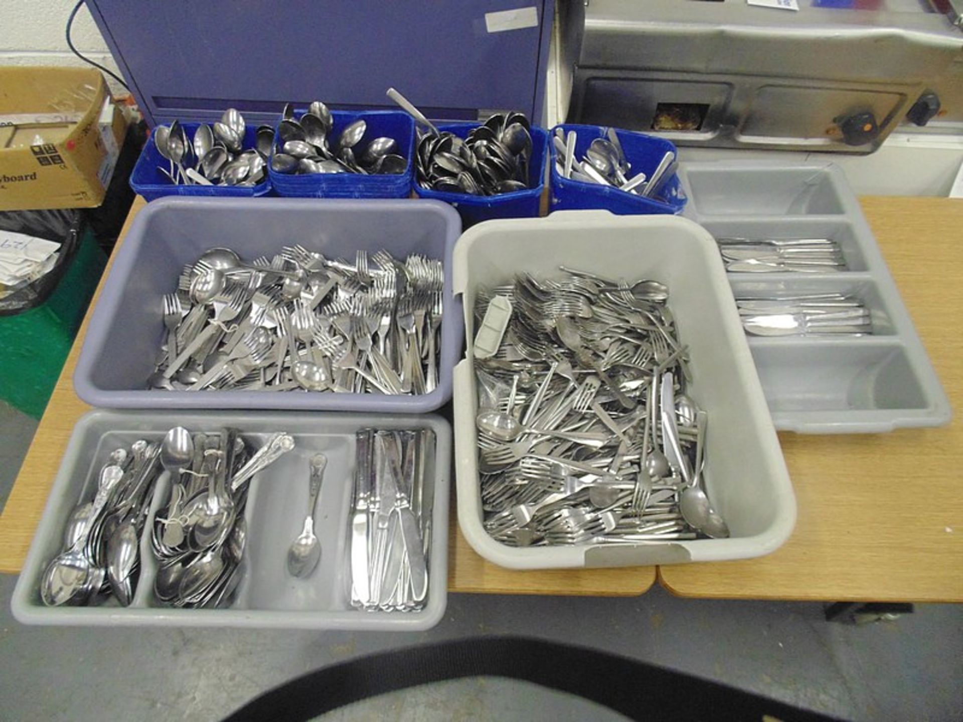 A large quantity of stainless steel cutlery – knives forks and spoons