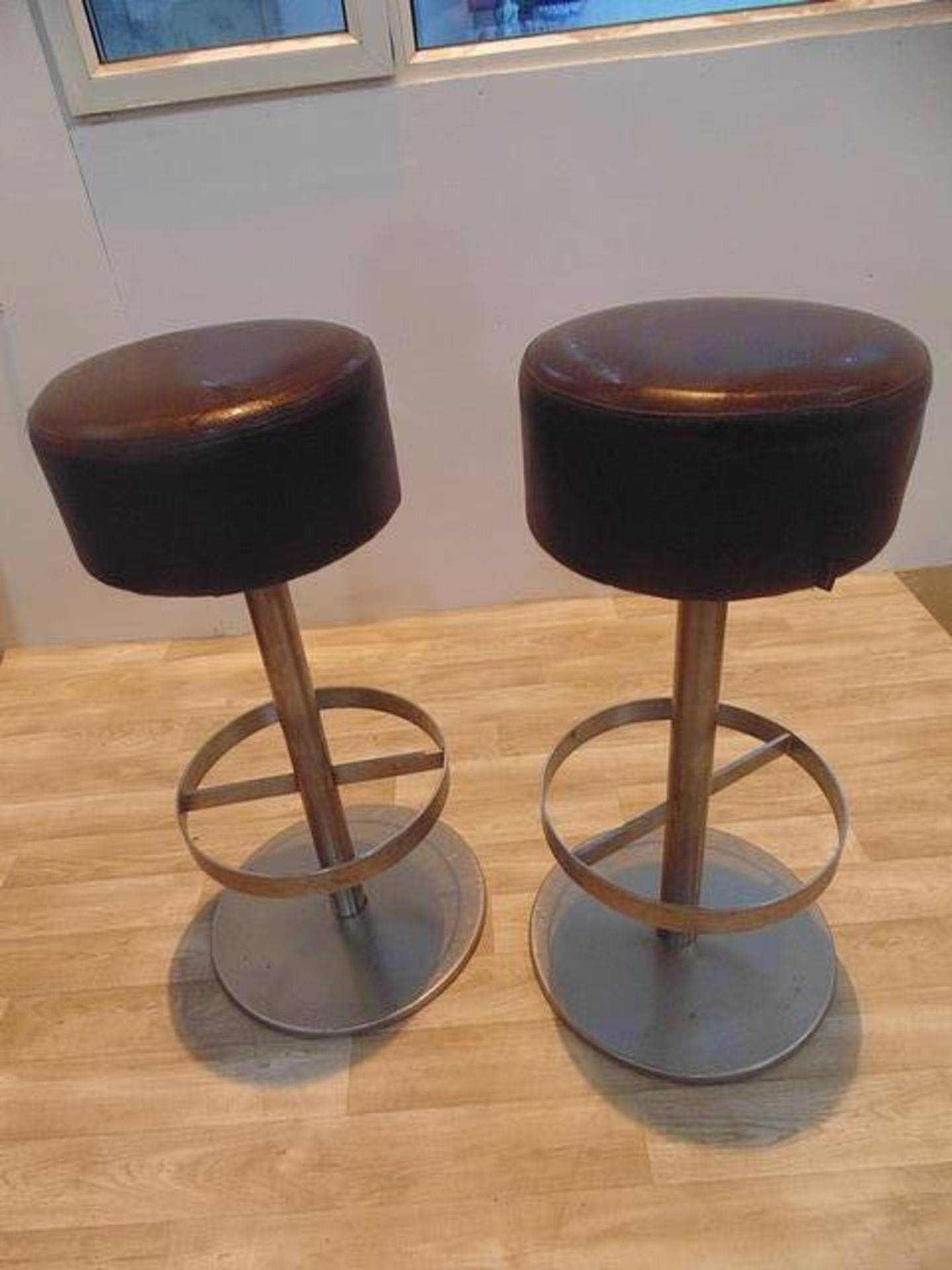 A pair of TX upholstered bar stools round shaped upholstered bar stools in faux leather 340mm
