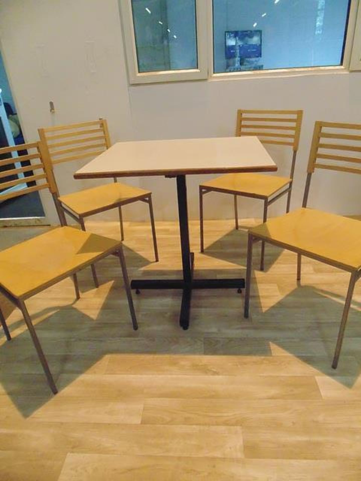 Laminated wood top dining table on metal frame complete with four beach and meal side chairs 580mm x