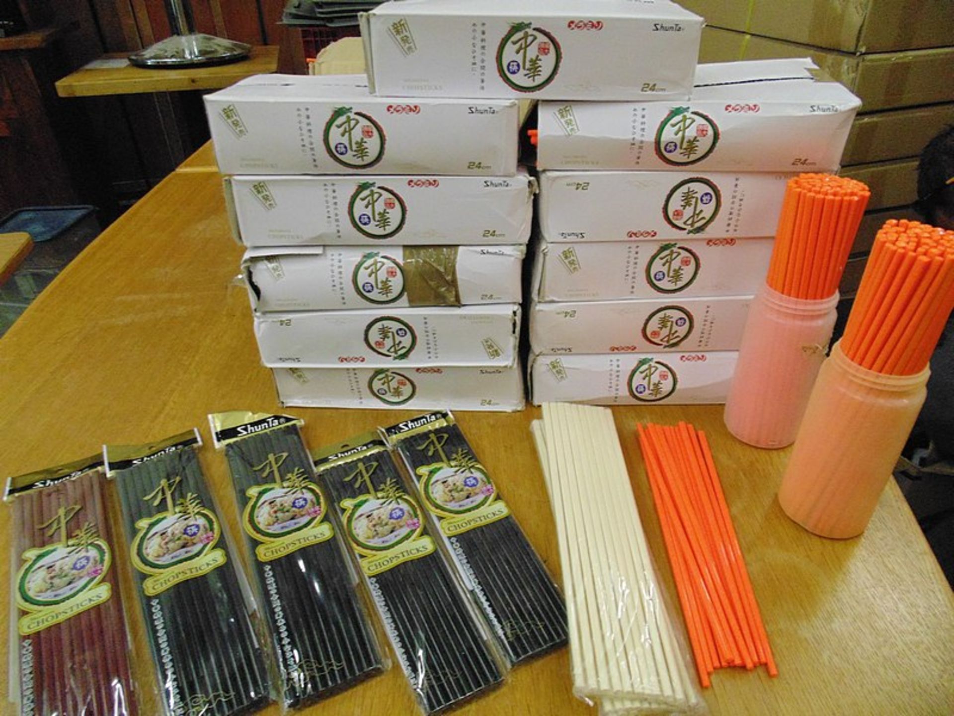 A large quantity of brand new boxed approximately 4000 pairs of orange chop sticks with other