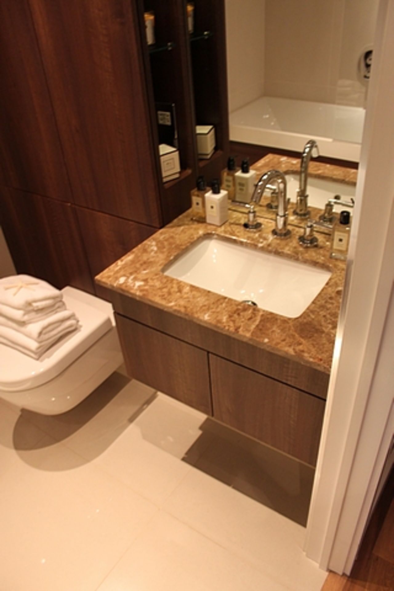 A Villeroy & Boch bathroom suite comprising of bath stone basin and vanity, WC pan and fittings