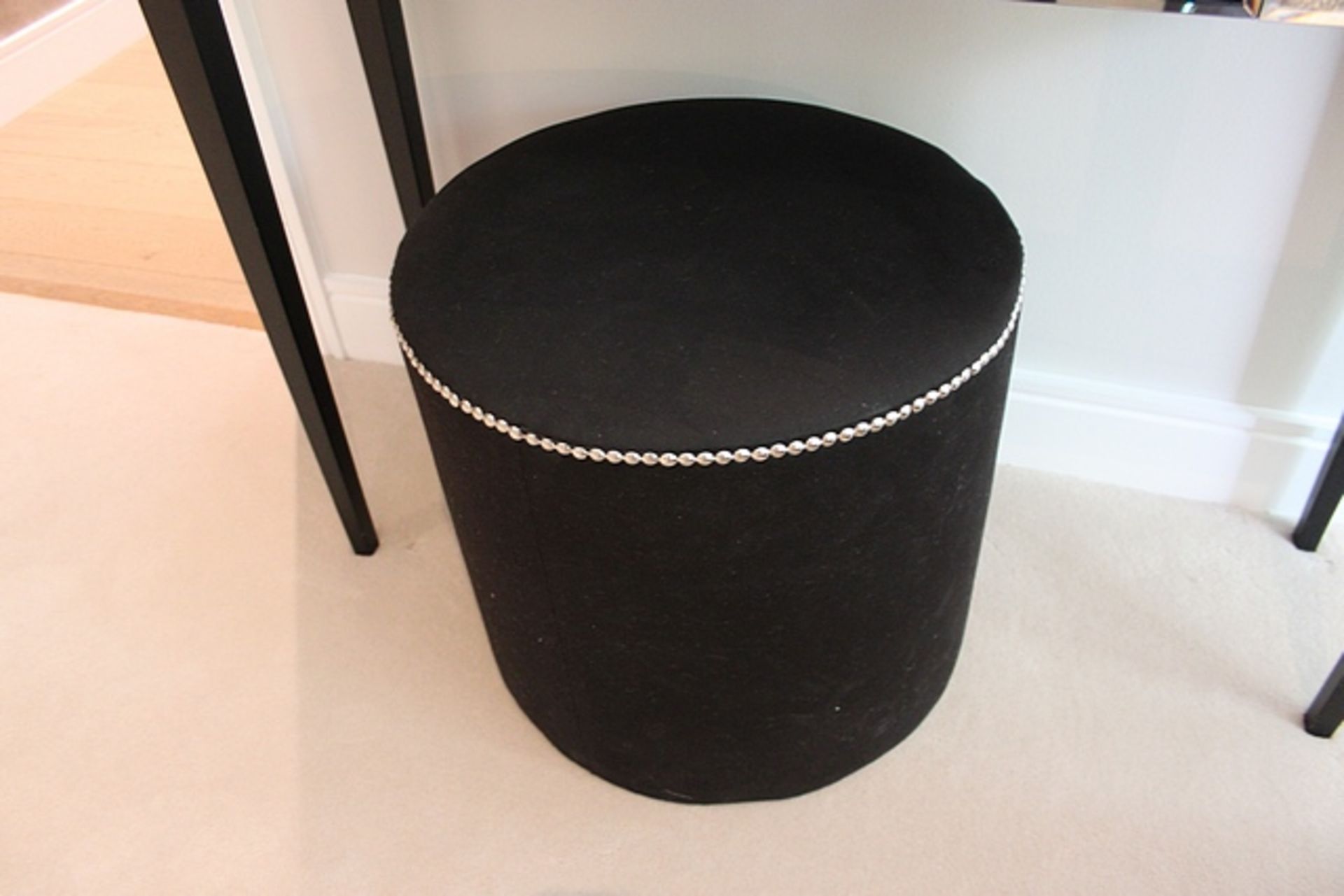 A black upholstered ottoman 450mm x 410mm