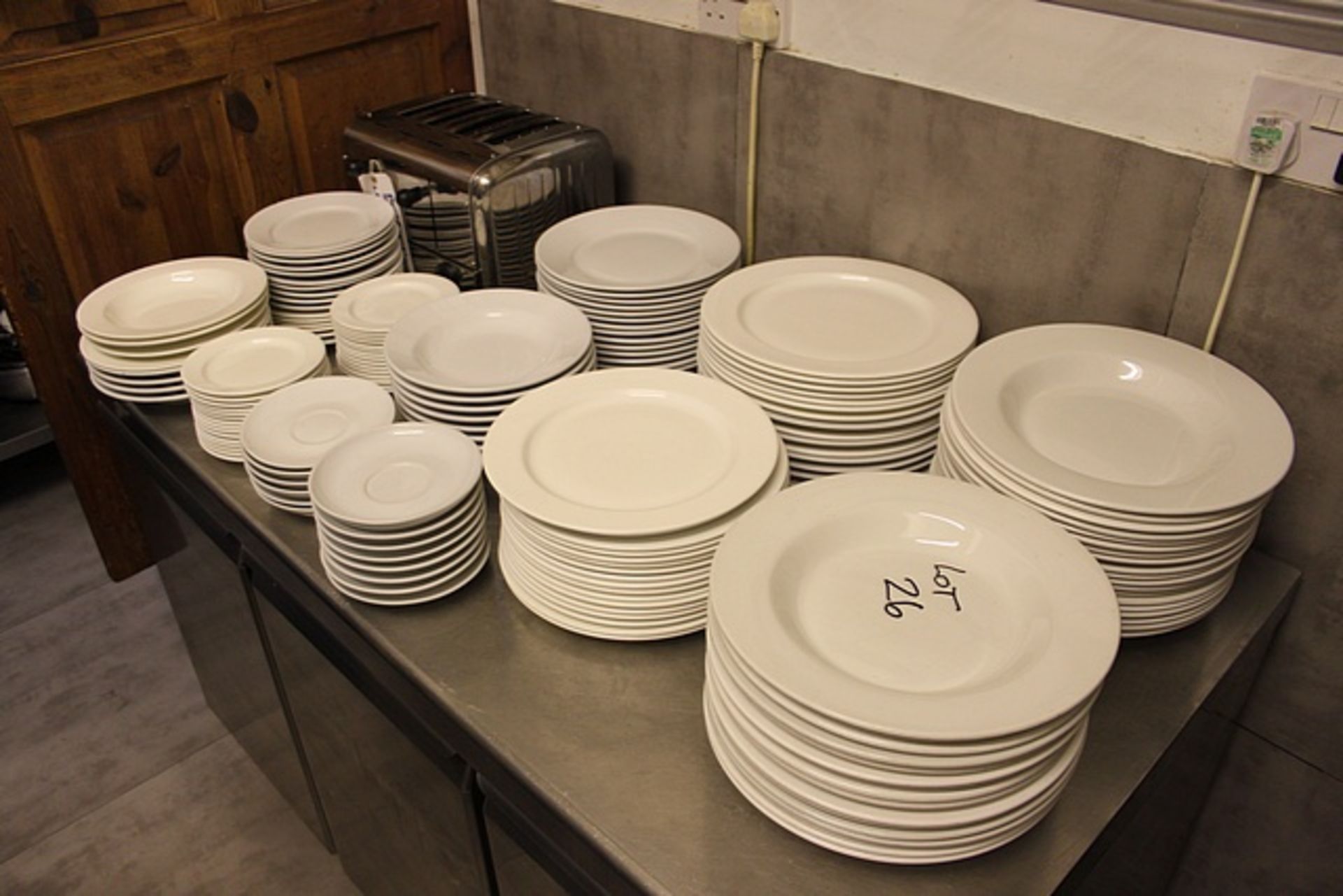 A large quantity of white table ware comprising of dinner plates, soup bowls, side plates as saucers