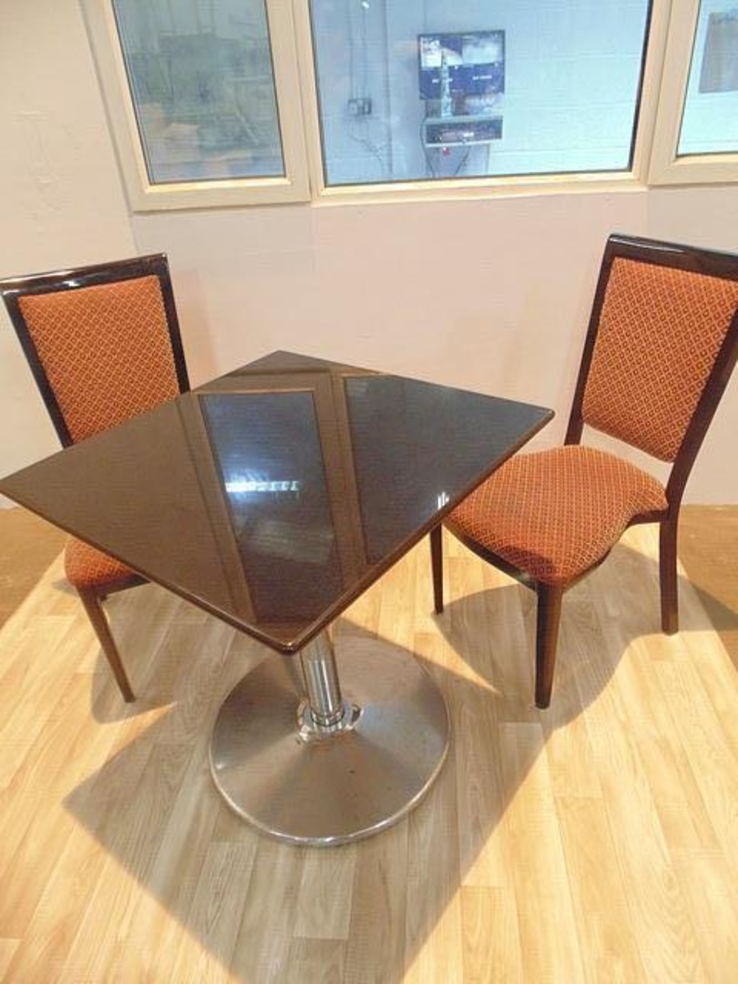 Black granite round top dining table with stainless steel pedestal complete with two side chairs