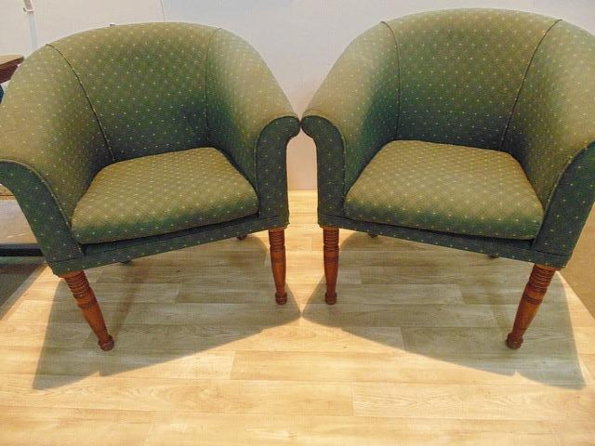 A pair of upholstered hardwood framed club / tub chairs in a green patterened fabric 460mm x 730mm x