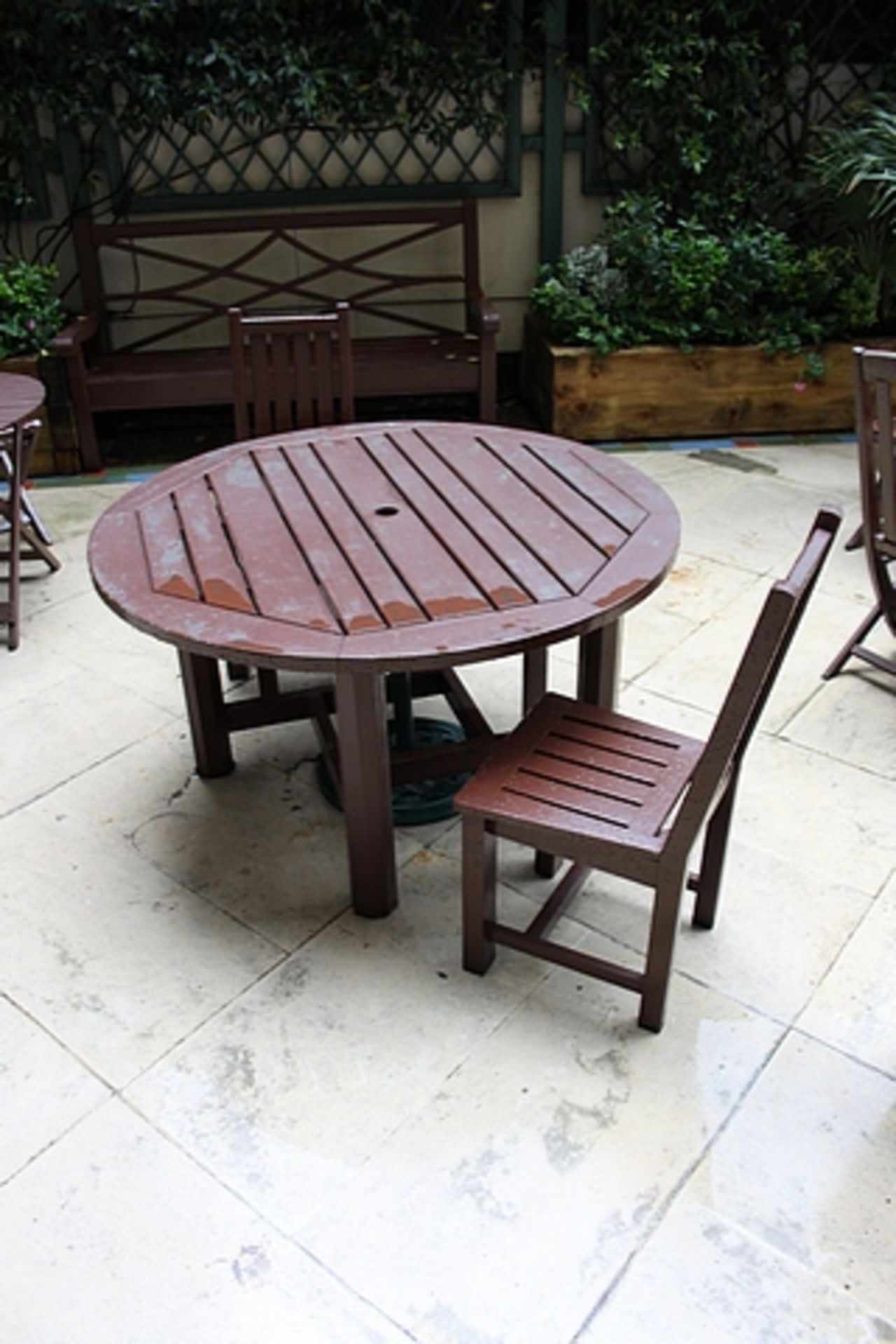 Classically styled 1300mm round stained teak garden table complete with 3 chairs all stained