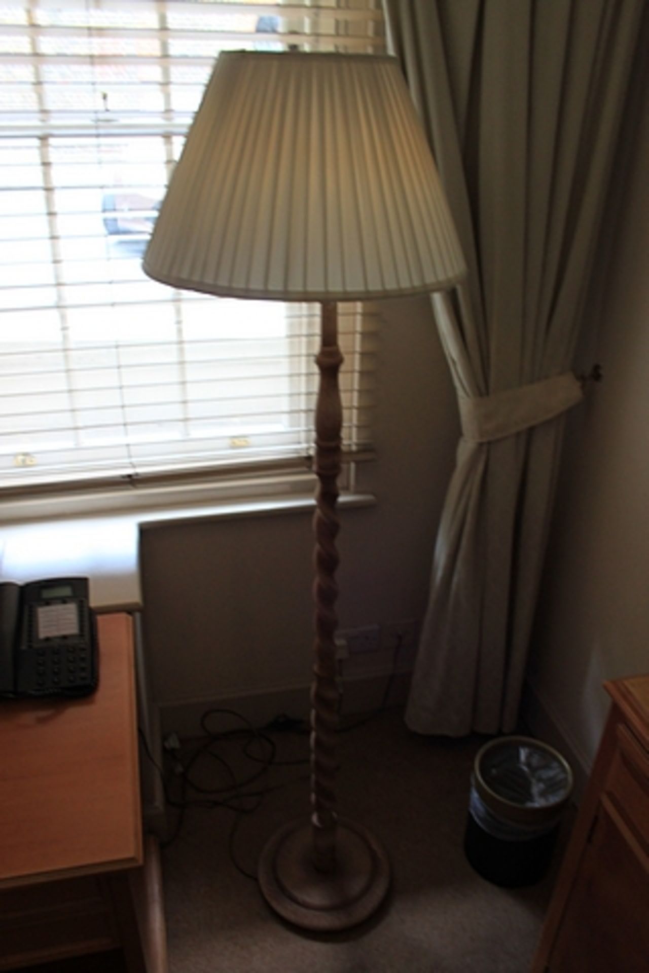 Barley twist floor lamp with linen shade features a carved coil of wood from base to shade topped