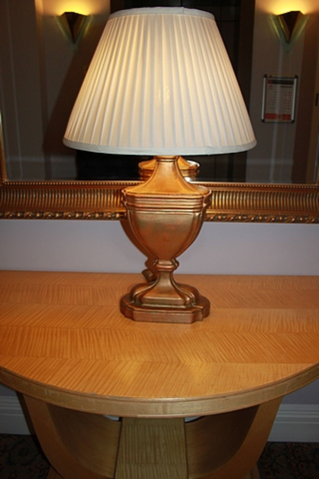 A gold painted table lamp in the form of a scroll urn with linen shade 750mm tall