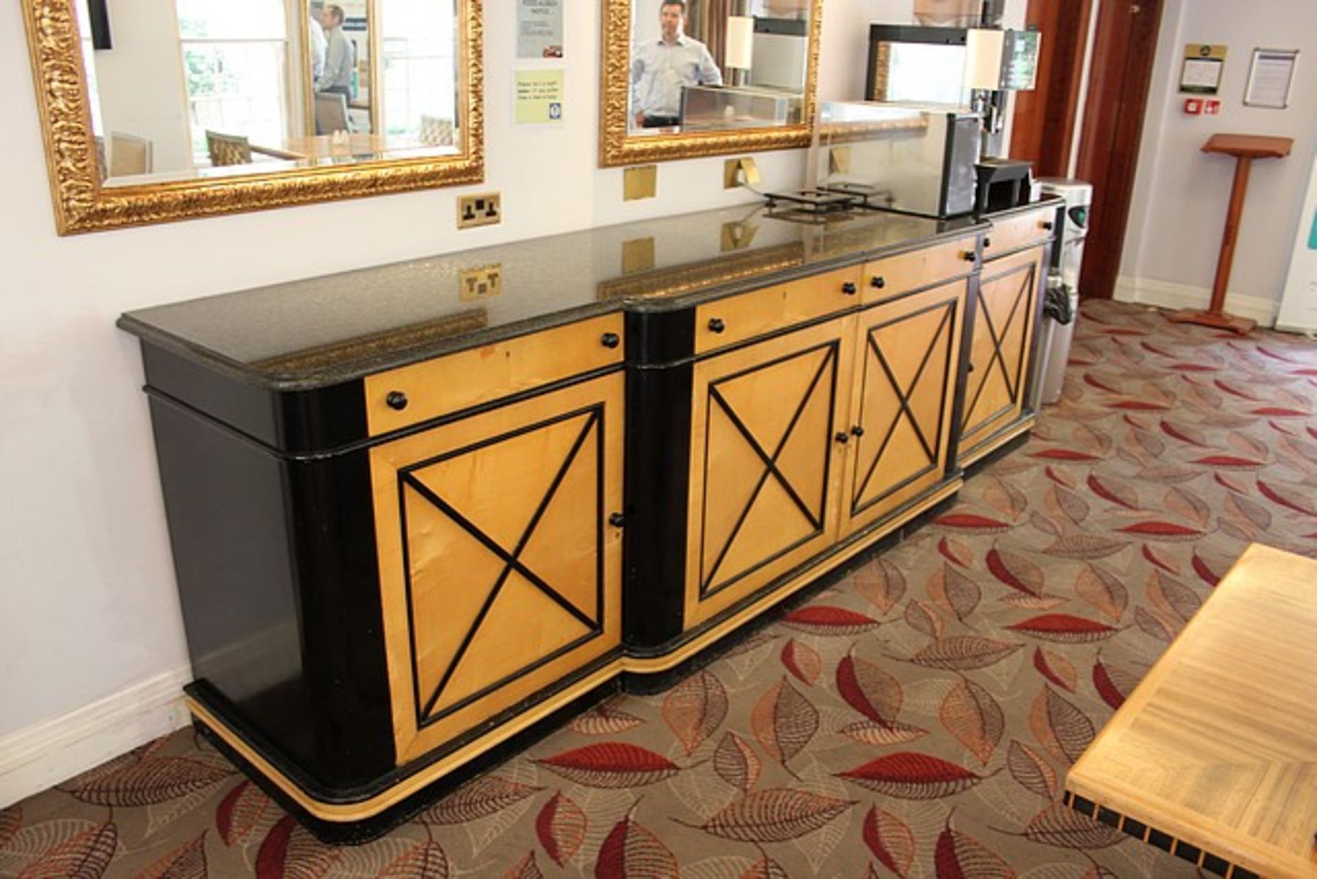 A Jules Leleu style buffet sideboard the breakfront rectangular granite top above four drawers and