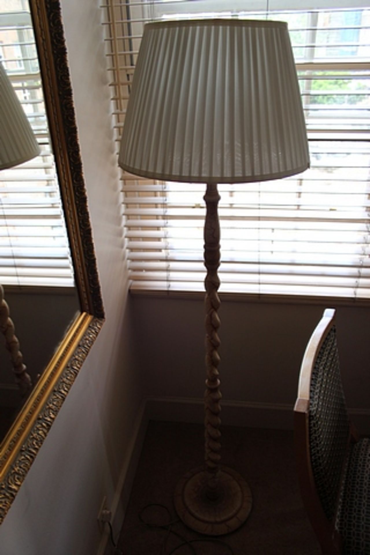 Barley twist floor lamp with linen shade features a carved coil of wood from base to shade topped