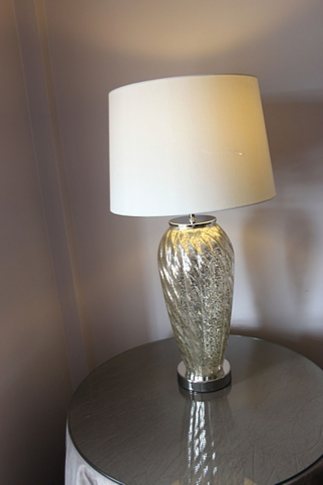 A pair of modern glass and chrome table lamps 660mm tall