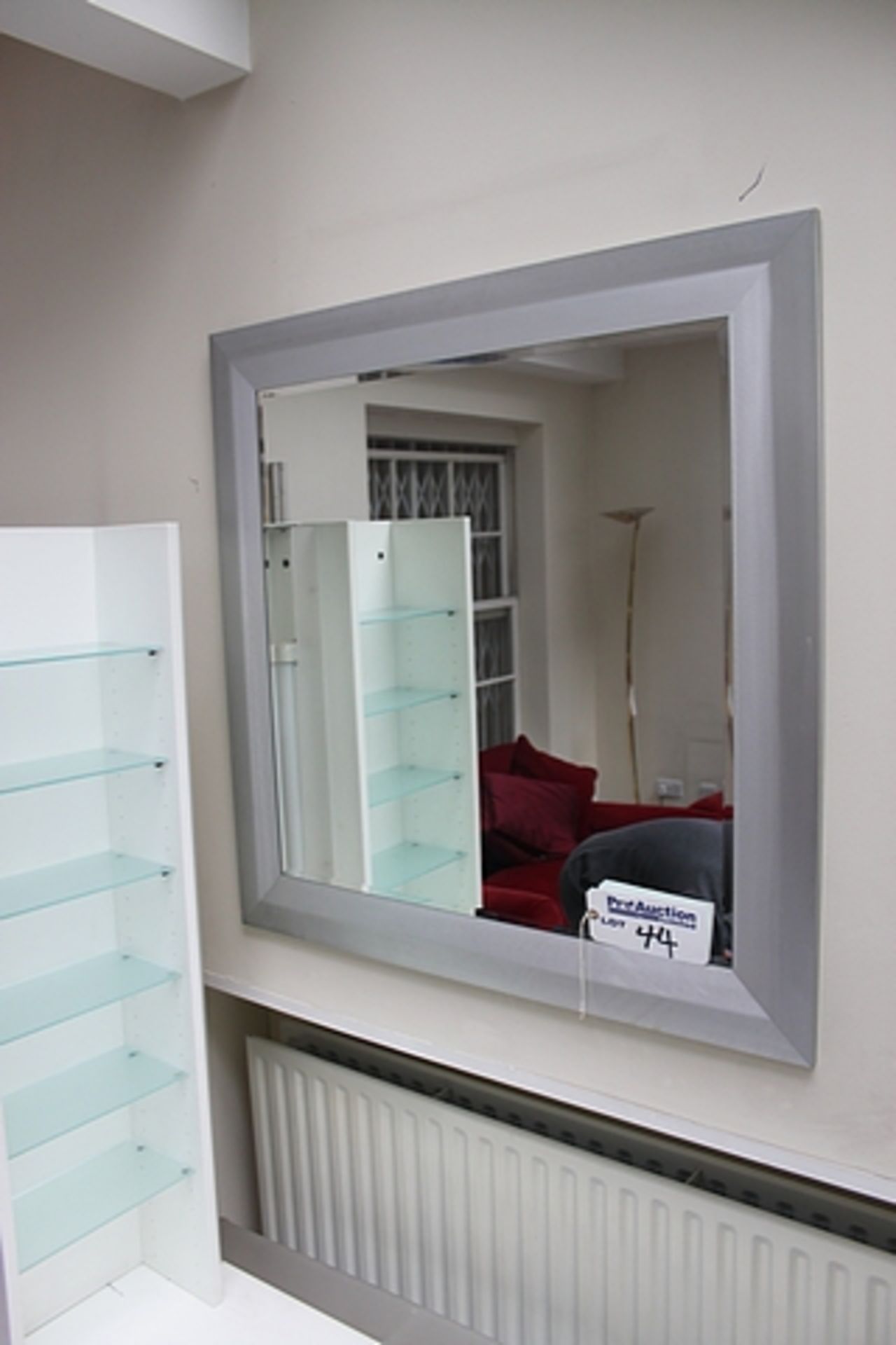 A bevelled wall mirror in silver metal frame 960mm x 960mm