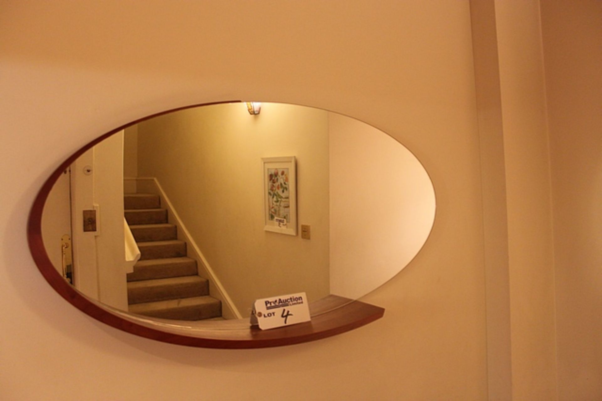 A retro oval shaped partial wood framed wall mirror 1230mm x 640mm