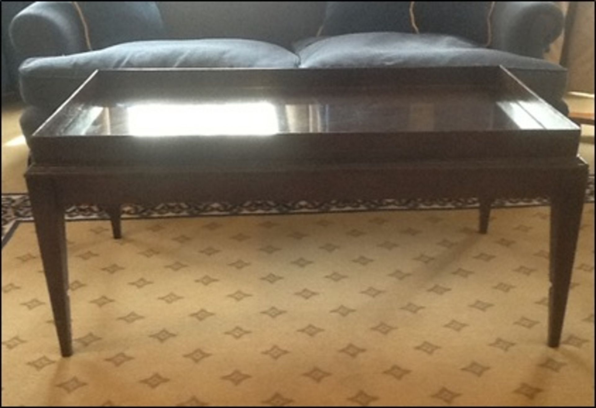 A mahogany tray top style coffee table mounted on square legs Room108Lift out charge 10