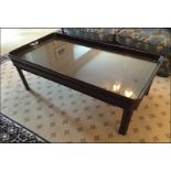 A mahogany tray top style coffee table mounted on square chunky legs Room107Lift out charge 10