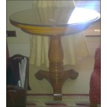 A light mahogany circular top occasional table on carved baluster pedestal mounted on tri-form