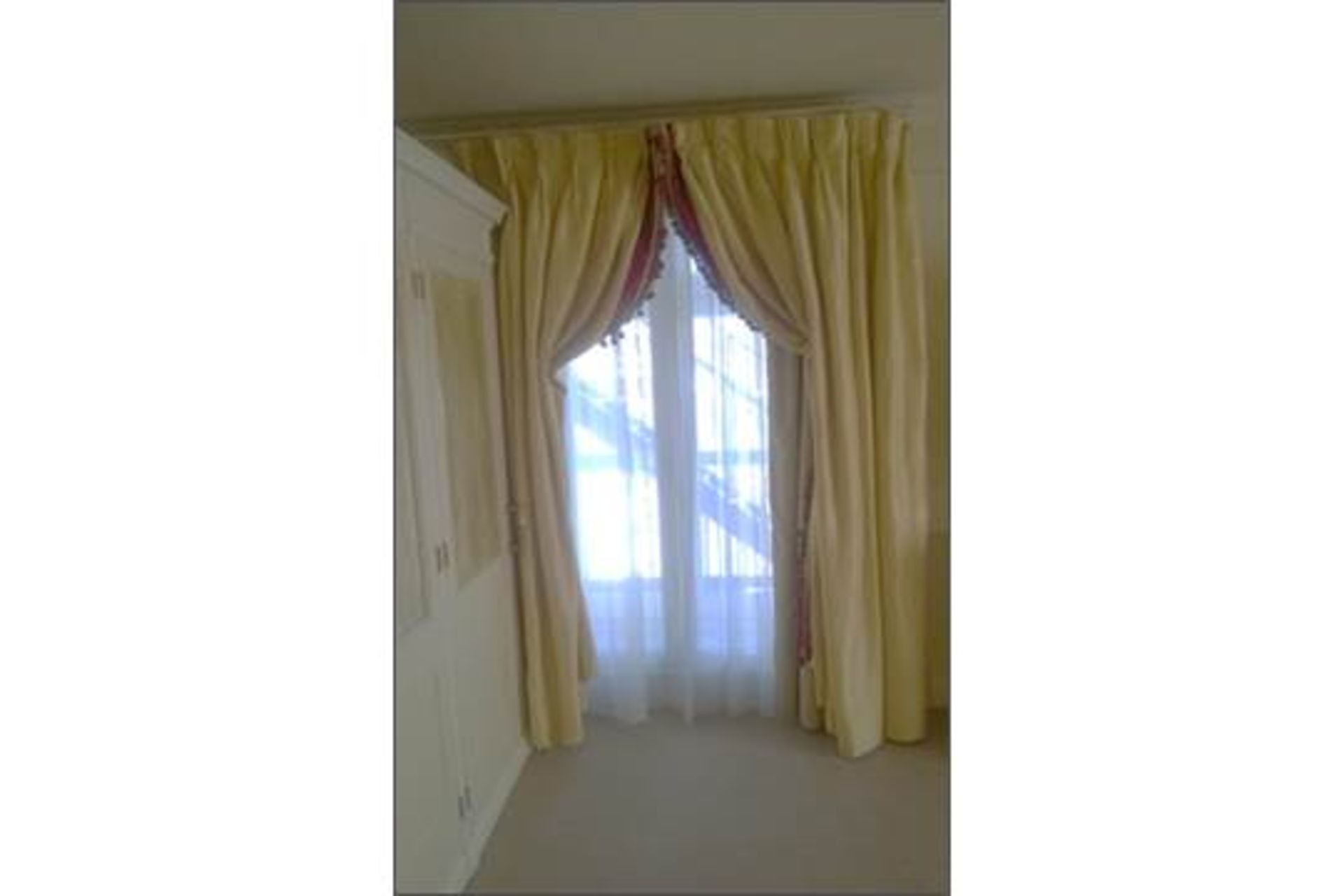 A pair of soft gold lined luxury drape curtains
