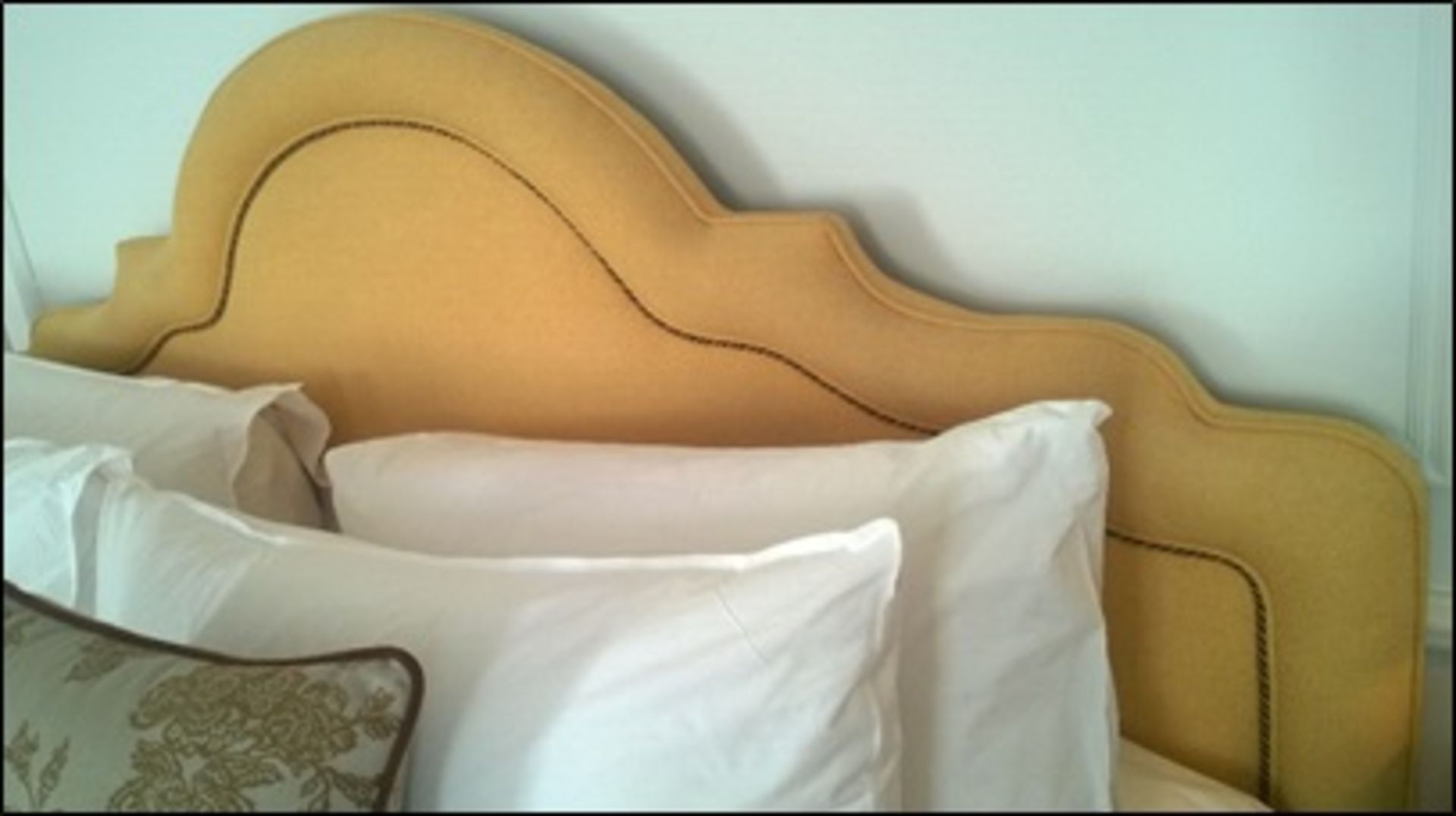 Portman upholstered headboard with elegant shaped top piping detail Room402Lift out charge 5