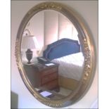 An ovoid shaped gilt framed wall mirror Room108Lift out charge 5