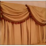 A pair of soft gold lined luxury drape curtains with swag valance pelmet Room307Lift out charge 15