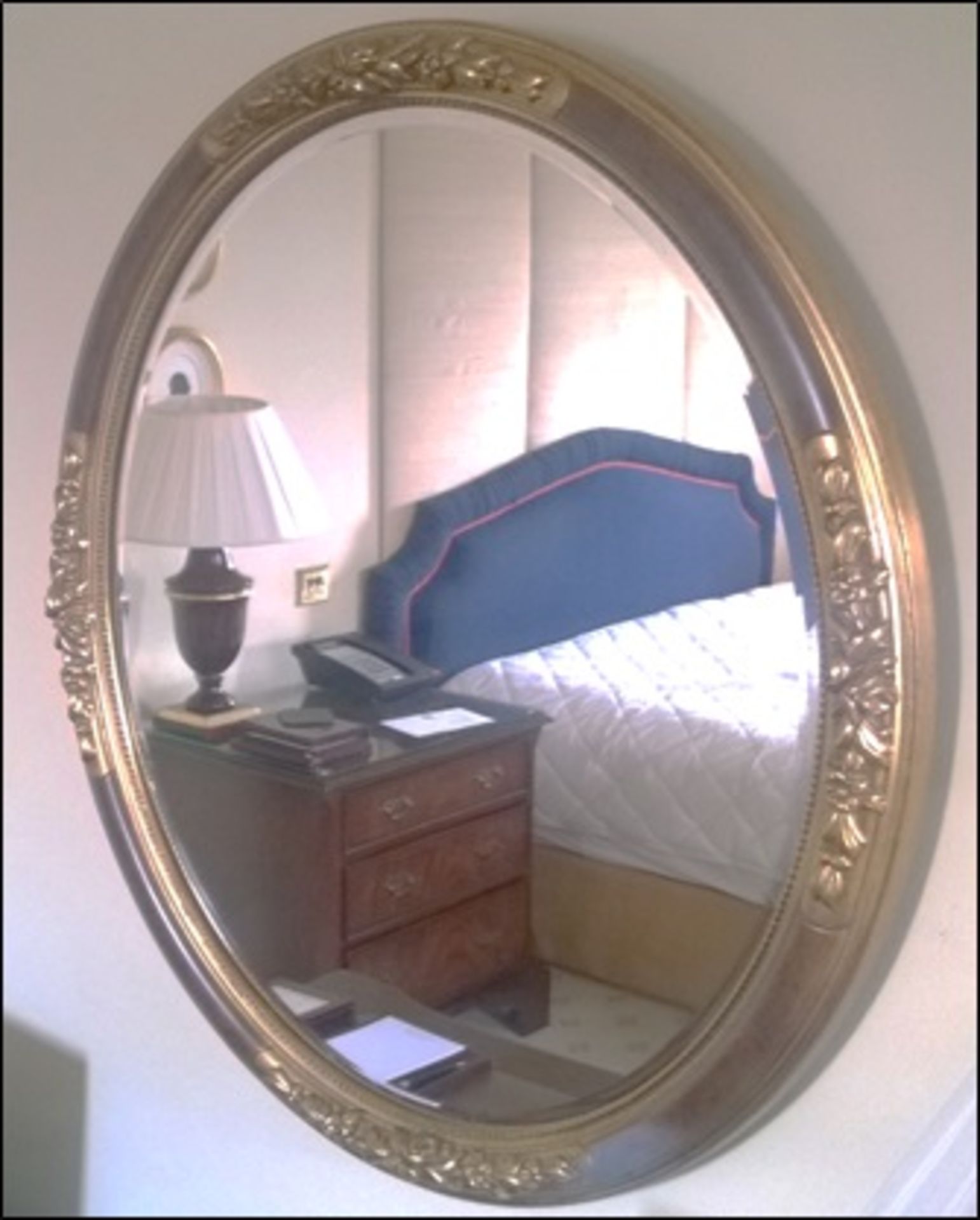 An ovoid shaped gilt framed wall mirror and a gilt wall dress mirror Room314Lift out charge 5