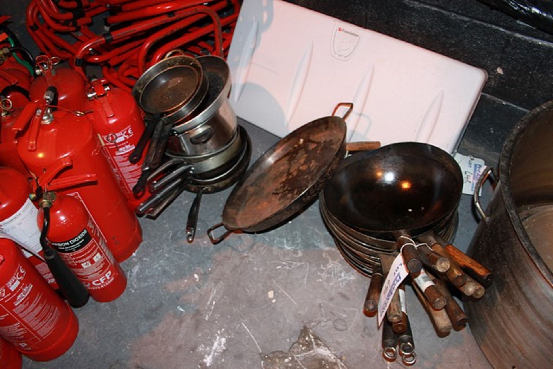 Various wok paella and frying pans as lotted