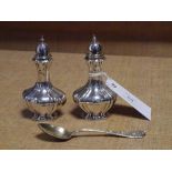 A pair of George V silver pepperettes, Birmingham 1912, of fluted baluster form; together with a