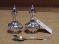 A pair of George V silver pepperettes, Birmingham 1912, of fluted baluster form; together with a