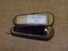 A George V 9ct gold mounted amber cigar holder, hallmarked for London 1926, in its original fitted