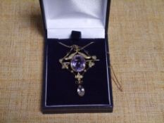 A 9ct gold amethyst and seed pearl pendant in the Edwardian taste, centred by an oval-cut stone