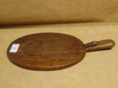A Robert "Mouseman" Thompson oak cheeseboard, oval, with carved mouse signature to the handle. 39.