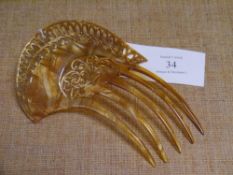 A lady's decorative hair comb, asymmetric pierced with pointed arches and foliate scrolls, on a five
