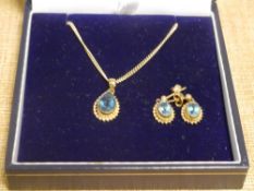 A suite of 9ct gold topaz jewellery comprising pendant and pair of drop earrings