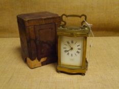 A French brass carriage clock, c. 1900, the white enamel dial with Roman numerals, R.L. Christie