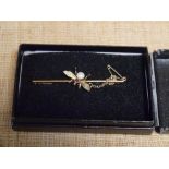 An Edwardian 9ct gold bug bar brooch, the insect set with a seed pearl and small ruby, with safety