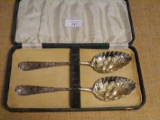 A cased pair of mid-Victorian Scottish silver berry spoons, William Coghill, Glasgow 1873, with