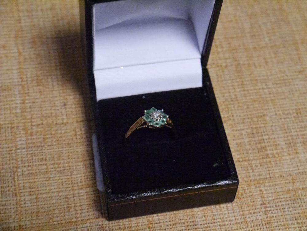 An emerald and diamond cluster ring, of flowerhead form, on a 9ct yellow gold band