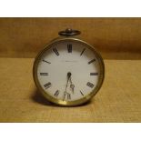 A late 19th century French brass drumhead desk clock, the white enamel dial with Roman numerals