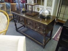 A Jacobean Revival oak dresser base, c. 1900, fitted with two panelled frieze drawers, on baluster