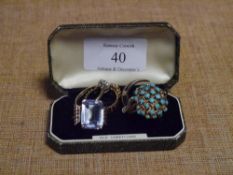 A group of four gem-set rings including turquoise, garnet etc; together with a gilt metal and enamel