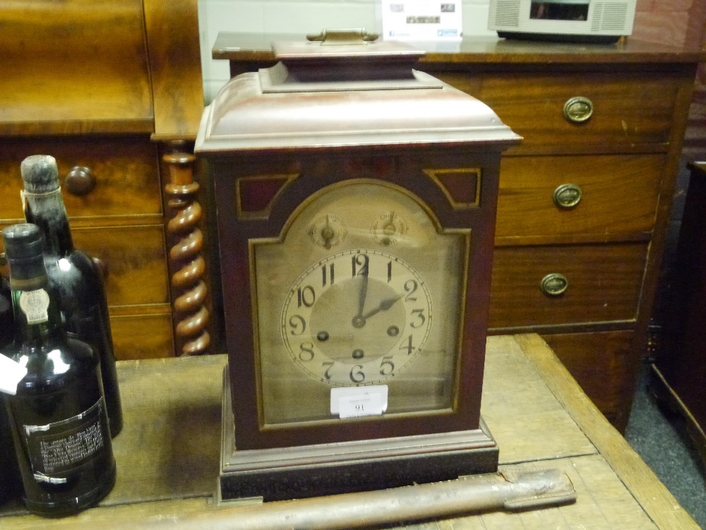 An early 20th century mahogany cased bracket clock, the case with caddy top and raised on bracket