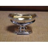 A Victorian silver table salt, London 1882, of shaped oval form with gadrooned border on a