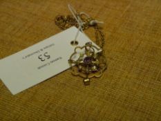 An Edwardian 9ct gold amethyst and seed pearl pendant, on a 9ct ropetwist chain with barrel clasp.