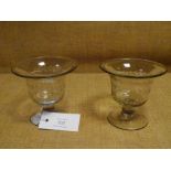 A pair of early 19th century etched glass sweetmeats, each with flared bowl, decorated with stylised