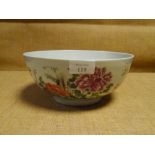 A Chinese porcelain bowl, painted in famille rose enamels with floral sprays and flowering boughs (