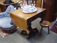 A William IV mahogany sofa table, with twin reeded flaps above three frieze drawers opposed by