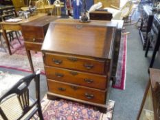 A small George III mahogany slant front bureau, the slope enclosing a fitted interior over three