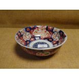 A Japanese Imari porcelain bowl, decorated in the characteristic palette with floral reserves. 18.